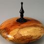 This hollow form is made from spalted Pecan from a friend in Arkansas, with an ebony finial. This piece of wood has a lot of variety in coloration and grain; it's difficult to choose which photos of it to display. It's about 6 1/2" tall and 7 1/2" wide.